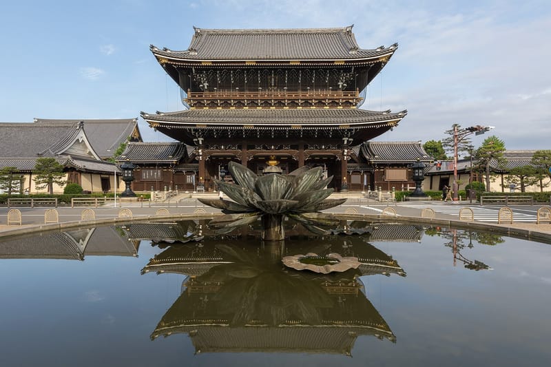 Founder's Hall gate of Higashi-Honganji Temple, seen from outside with mirror reflection in the water of a fountain, Tokiwacho, Shimogyo Ward, Kyoto, Japan. Built in 1911, width 31