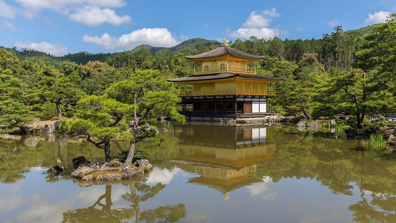 Wide-frame view and water reflection of Kinkaku-ji Temple, a sunny day, Kyoto, Japan.